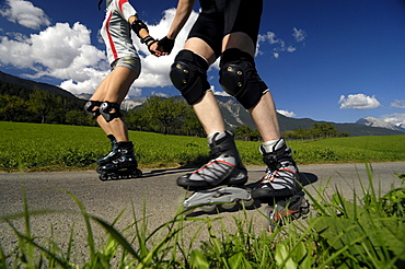 Couple on inline skates, Inline skating, near Imst, Tyrol, Austria