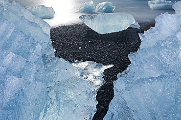 Icebergs in the waves in the glacial lake, Jokulsarlon, East Iceland, Iceland