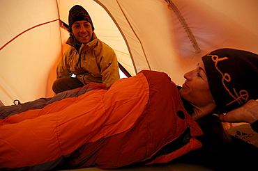 Woman and man inside a tent, Camping in Winter at Hochgrat, Allgaeu Alps, Bavaria, Germany, Europe