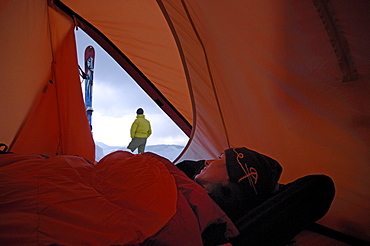 Woman inside a tent looking outside, Camping in Winter at Hochgrat, Allgaeu Alps, Bavaria, Germany, Europe