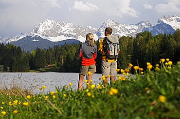 Couple on the lake shore admiring the view, Lake Gerold, near Klais, Upper Bavaria, Bavaria, Germany, Europe