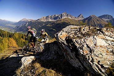 Couple on a mountain bike tour, MTB, mountainbiking near Svognin, View towards Albula Range, Grisons, Switzerland