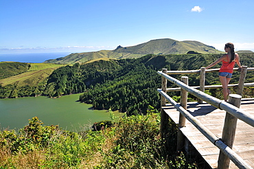 Young woman enjoying the view, Caldeira Funda, Island of Flores, Azores, Portugal