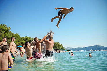 Young people splashing around in the sea, beach at Bar, Adriatic coastline, Montenegro, Western Balkan, Europe