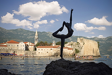 Sculpture of a nude female acrobat in front of the old town of Budva, Stari Grad, Adriatic coastline, Montenegro, Western Balkan, Europe