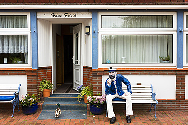 Seafarer and duck in front of a frisian house, Juist Island, Nationalpark, North Sea, East Frisian Islands, East Frisia, Lower Saxony, Germany, Europe