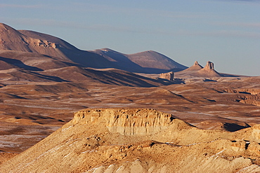 Barren rock formations on a plateau in the Band-i-Amir area lit by the late afternoon sun, Bamian Province, Afghanistan