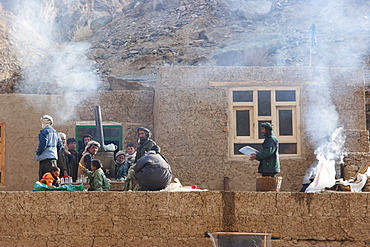 People by a samovar on a house by the entrance of the Pai Mori Gorge, Bamian Province, Afghanistan