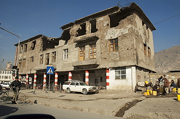 Albeit the top floor of this building in Kabul has been destroyed by shelling, the lower stories remain inhabited, , Afghanistan