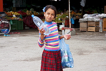Girl collecting bottles, Tirana, Albania