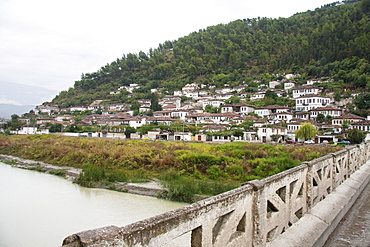 Gorica Bridge (17th century) over the Osumi River and houses in the Gorica District, Berat, Albania