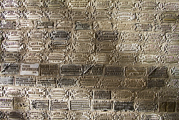 Thanksgiving plaques on a shrine at the Difunta Correa Sanctuary, Vallecito, San Juan, Argentina. La Difunta Correa is the most popular of Argentina's folk saints. She was a woman whose husband was forcibly recruited around the year 1840, during the Argentine civil wars. Becoming sick, he was then abandoned by partisans. In an attempt to reach her sick husband, Deolinda took her baby and followed the tracks of the partisans through the desert of San Juan Province. When her supplies ran out, she died. Her body was found days later by gauchos, however they found the baby still alive, feeding from the deceased woman's miraculously ever-full breast. Once the folk tale became known, her devout followers believe her to perform miracles and intercede for the living. Cattle keepers and truck drivers create small altars throughout Argentina and leave bottles of water as votive offerings.