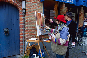 Painters painting a street scene, Bruges (Brugge), West Flanders, Belgium