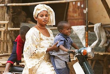 Woman and boy on a motorcycle in Segou, Mali