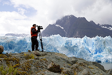 Videographer in front of the San Rafael Glacier, Laguna San Rafael National Park, AisâˆšÂ©n Region, Chile