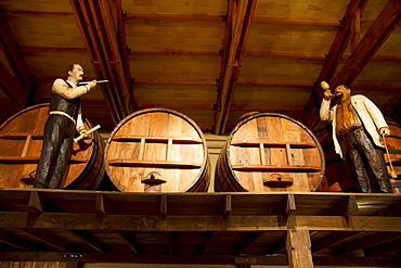 Life size handcrafted wooden figures illustrate the various stages of winemaking and distilling, as practiced in the 1900s, on display at the Wine Museum of Estancia El Cuadro, Casablanca Valley, Valparaiso Region, Chile