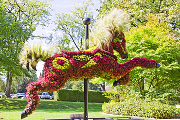 Ornamental hedge in the shape of a carousel horse in front of the Shadbolt Centre for the Arts, Burnaby, British Columbia, Canada