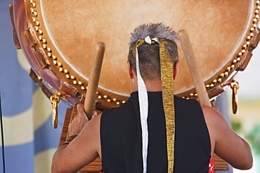 Kenny Endo performing on the Taiko, a traditional Japanese drum at the Powell Street Festival in Woodland Park, Vancouver, British Columbia, Canada