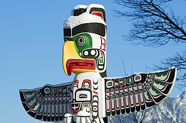 Thunderbird House Post carved in Kwakiutl style by Tony Hunt covered in snow in Stanley Park, Vancouver, British Columbia, Canada