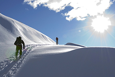 Skiers Heading up Cloudburst Mountain, Coast Mountains, British Columbia