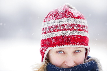 Woman bundled up, wearing toque on snowy winter day, Winnipeg, Manitoba