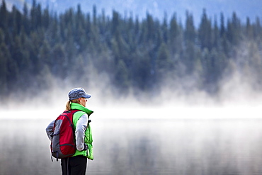 Hiker on misty fall morning, Maligne Lake, Jasper National Park, Alberta