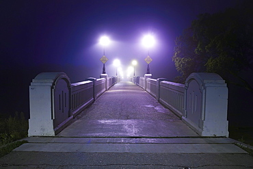 Assiniboine Park Footbridge crossing Assiniboine River on foggy fall morning, Winnipeg, Manitoba