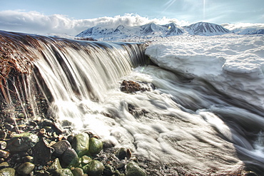 Meltwater creating mini waterfall, along Haines Highway, northern British Columbia