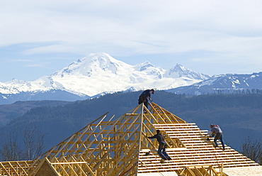 Construction Crew at Work on New Home with Mount Baker in the Background, Abbotsford, British Columbia