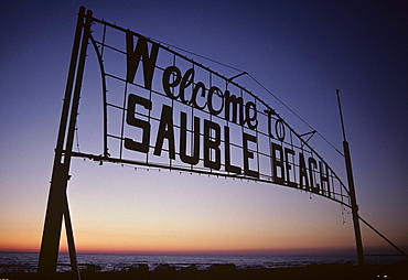 Sign over entrance to beach at sunset, Sauble Beach, Ontario, Canada