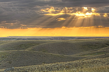 Rays of sunset light between the clouds, Grasslands National Park, Saskatchewan