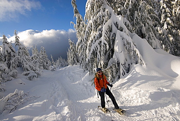 Portrait of a woman snowshoeing up Hollyburn Mountain, Cypress Provincial Park, near Vancouver, British Columbia