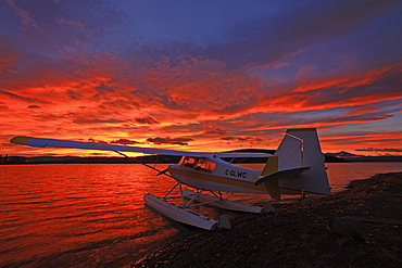 A float plane facing the sunrise over Teslin Lake, Yukon