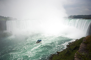 Tour boat heading towards the waterfalls, Niagara Falls, Ontario