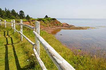 Wooden fence along the cliff tops overlooks the coastline, Cape Bear, Prince Edward Island