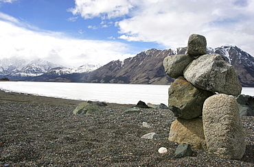 Inukshuk along the spring-time shores of the Frozen Kluane Lake, Kluane National Park, Yukon