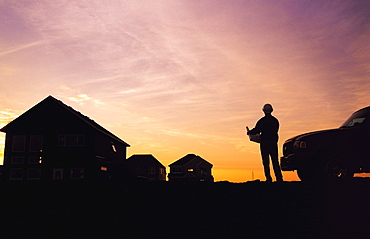 Worker looks at Housing Development Plans in a New Housing Development, Winnipeg, Manitoba