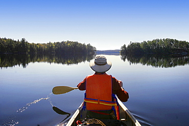 Canoeist on Big Trout Lake, Algonquin Park, Ontario