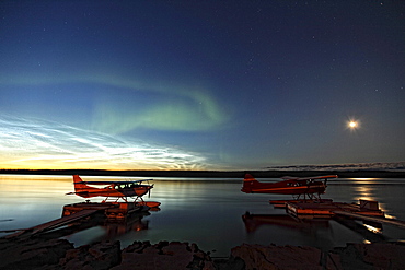 Aurora borealis and over the MacKenzie River with float planes in foreground, Fort Simpson, Northwest Territories