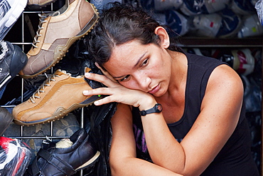 Woman resting in a shoe store, Guayaquil, Guayas, Ecuador