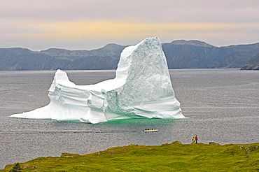 Hikers and Boaters view Iceberg in Trinity Bay off the Bonavista Peninsula of Eastern Newfoundland