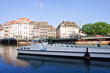 Tour boat by Alsatian houses on the Quai des Bateliers by the Ill river, Strasbourg, France