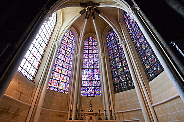 Altar and stained glass windows in a radiating chapel of Chartres Cathedral, Chartres, France