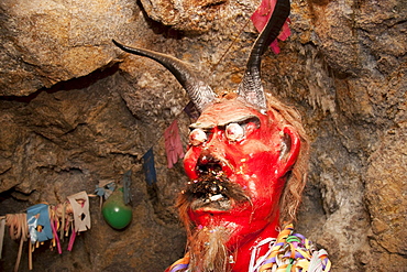 Ceramic figure of el Tio or Supai, a creature with horns, gleaming eyes and a big penis, that in fact is not really satanic. It was introduced by the Spaniards in the 16th Century to the mines of Potosi. According to tradition, el Tio (The Uncle) rules over the mines of Cerro Rico, simultaneously offering protection and destruction. Over 500 chambers with statues to honour him have been constructed in Cerro Rico, so miners can leave offerings of tobacco, liquor and coca leaves to invoke his goodwill and protection., Potosi Department, Bolivia