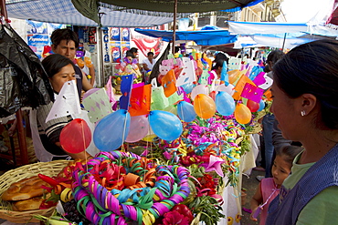 Gift basket vendor at the Jueves de Comadres market during Carnaval Chapaco, Tarija, Bolivia