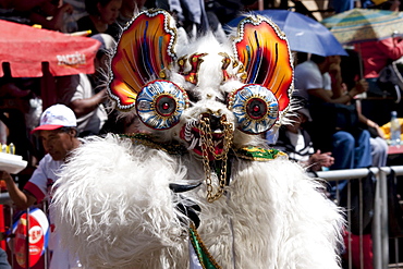 Diablada dancer wearing an elaborate devil mask and costume in the procession of the Carnaval de Oruro, Oruro, Bolivia