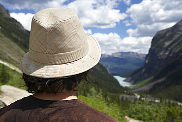 Young man looking out at Lake Louise, Banff, Alberta