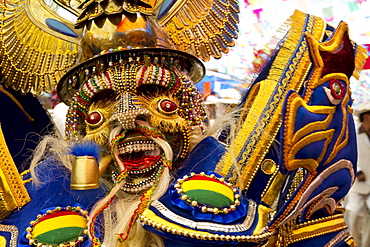 Morenada dancer wearing an elaborate mask and costume in the procession of the Carnaval de Oruro, Oruro, Bolivia