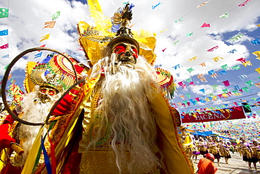 Morenada dancers wearing elaborate masks and costumes in the procession of the Carnaval de Oruro, Oruro, Bolivia