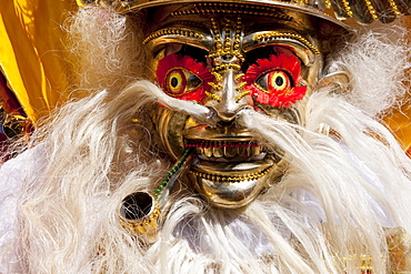 Morenada dancer wearing an elaborate mask and costume in the procession of the Carnaval de Oruro, Oruro, Bolivia